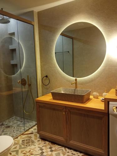 a bathroom with a sink and a mirror at Luxury Villas Chrysa Private Pool & Spa in Nafplio