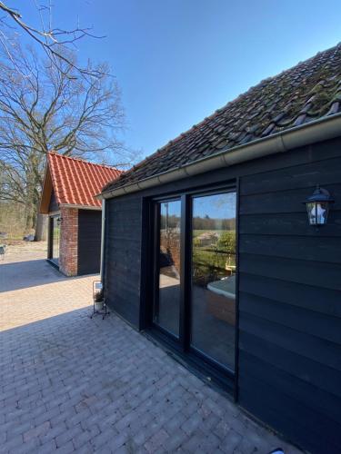 a large sliding glass door on a house at Domestico Bed & Breakfast in Lage Mierde