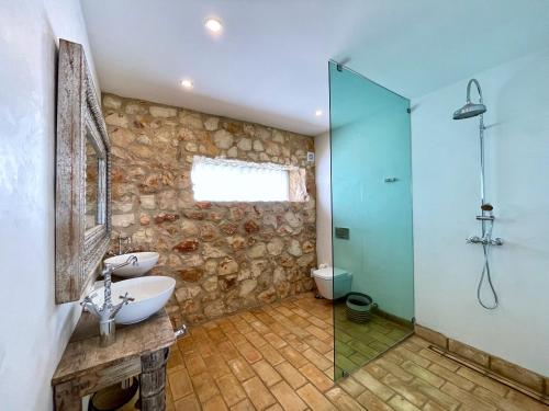 a bathroom with a sink and a glass shower at Alvor Bela Vista I in Alvor