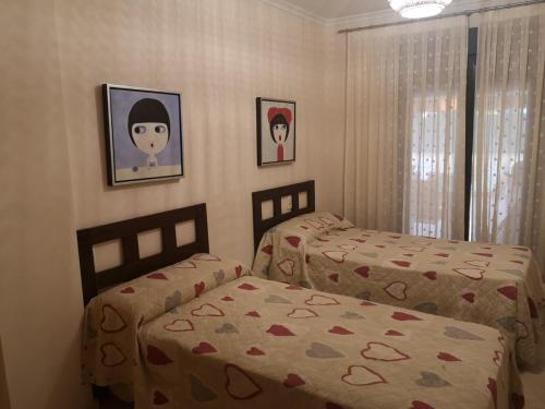 a bedroom with two beds and two pictures on the wall at Javea: Apartment/ flat - Jávea in Jávea