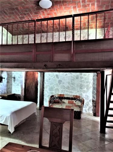 a room with two bunk beds and a bench and a table at Hotel Casa de Lirio Diamante in Acapulco