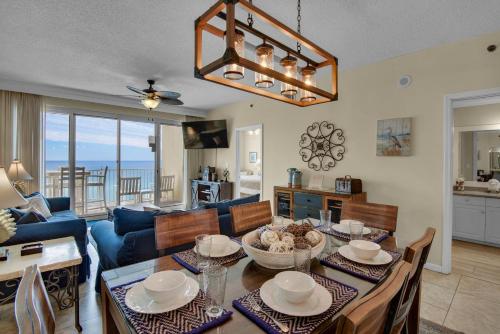a dining room and living room with a table and chairs at Leeward Key 905- Suite Sea-Cret in Destin