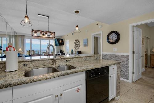a kitchen with a sink and a counter top at Leeward Key 905- Suite Sea-Cret in Destin