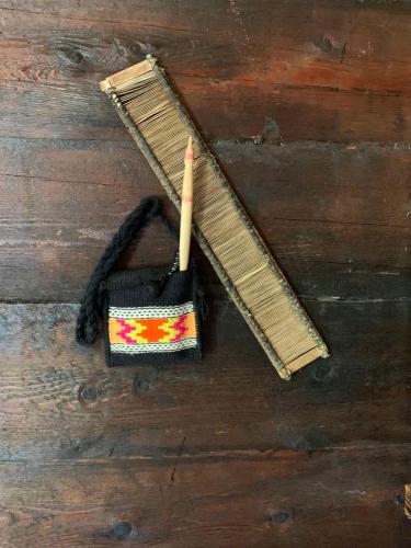 a wooden table with a wooden ruler and a pencil at Etno brvnara TAMARA in Kremna