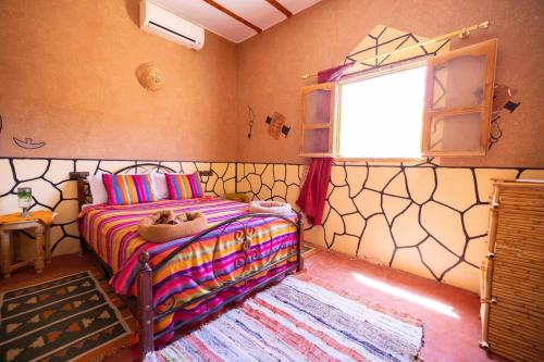 Postel nebo postele na pokoji v ubytování Riad Tigmi du Soleil