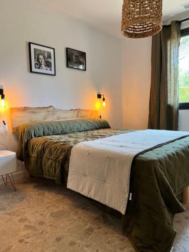 a bedroom with a large bed in a room at Mazet Brunelly in Paradou