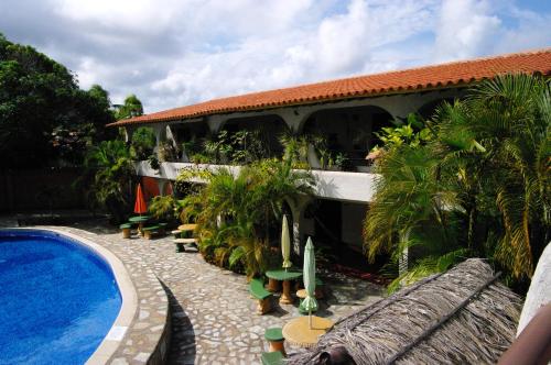 a resort with a swimming pool and a building at Posada Las Ross in La Mira