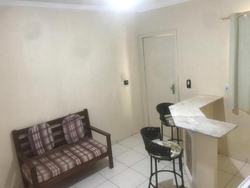a living room with a couch and a chair at Hotel Fênix in Barreiras