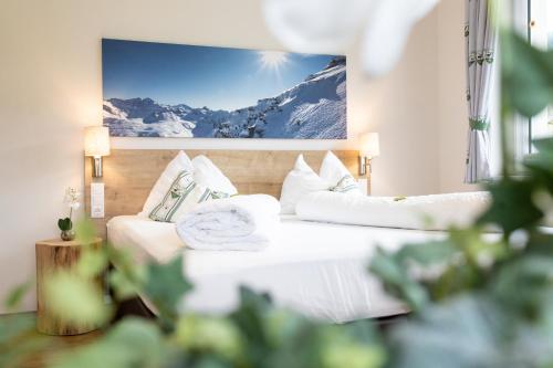 una habitación de hotel con 2 camas y una foto de una montaña en Appartements AUSZEIT with private SPA, en Embach