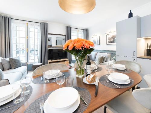 une salle à manger avec une table et des chaises dans l'établissement LivinParis - Luxury 2 Bedrooms Centre Pompidou, à Paris