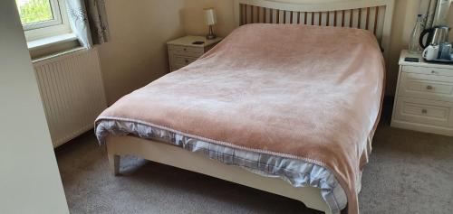 a bedroom with a bed and a window at Victoria Farm in Lutterworth