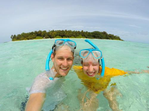 two people in the water in the ocean at Arora Inn in Maafushi
