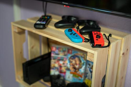a wooden table with two video game controllers on it at TREEHOUSE - KiDS PARADISE - CENTRAL - SSC in Winterberg