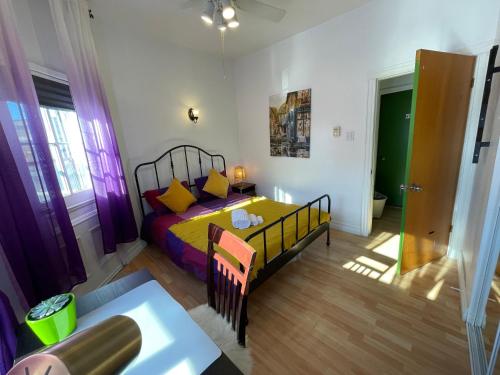 a bedroom with a bed and a table in it at Chambres EL MEDITERRANEO Rooms in Montréal