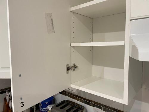 a kitchen with white cabinets and a sink at Chambres EL MEDITERRANEO Rooms in Montréal