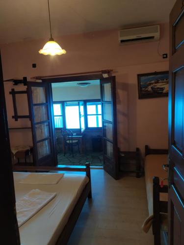 a room with a bed and a room with a door at Triple studio room with the most beatifull view in Mylopotamos in Tsagarada