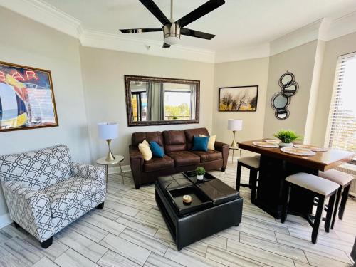 a living room with a couch and a table at 210 Sea Gem Oceanfront Pet Friendly Oceanfront in Myrtle Beach