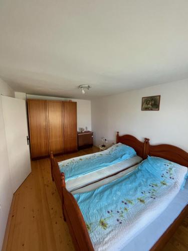a bedroom with two beds with blue sheets at Apartman Magdalena in Banja Koviljača