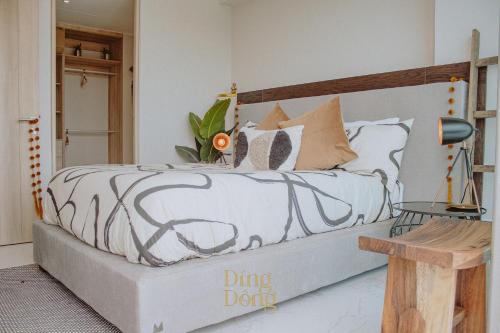 a bedroom with a bed with a black and white comforter at Máritima Golf New apartment private beach access in Nuevo Vallarta 