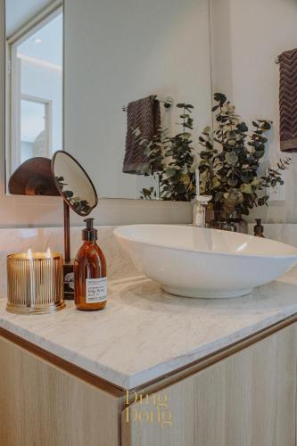 a bathroom counter with a bowl sink and a mirror at Máritima Golf New apartment private beach access in Nuevo Vallarta 