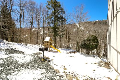 a yellow object in the snow next to a building at Beech Manor by VCI Real Estate Services in Beech Mountain