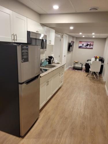 a kitchen with a refrigerator and a counter top at House of Love in Winnipeg