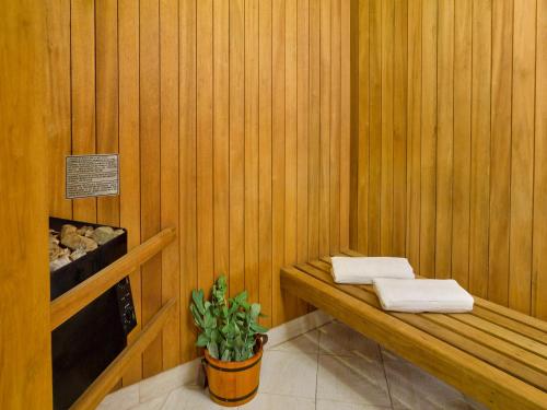 
a wooden bench next to a wooden wall at Hotel Estelar Miraflores in Lima
