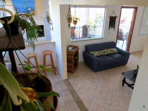 a living room with a couch and a table at Casa com Vista Panorâmica da Praia de Pontal do PR in Balneário Praia do Leste