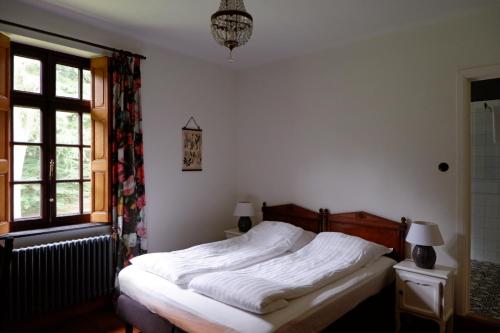 a bedroom with a bed and a window at Het Domherenhuis B&B, Restaurant Calice in Heusden - Zolder