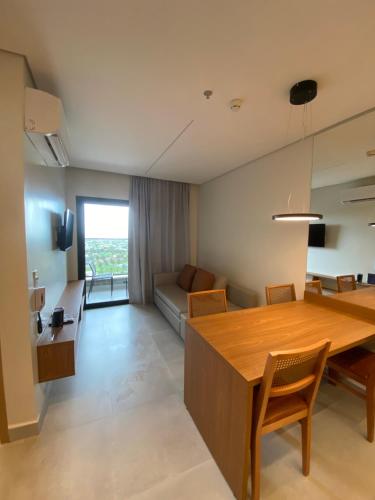 a living room with a table and a couch at Salinas GAV Resorts in Salinópolis