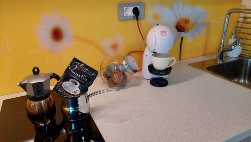 a kitchen counter with a coffee maker and other appliances at Apartma Marjetica in Gozd Martuljek