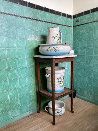 a shelf with a sink and bowls on it at The Old Bookstore in Flateyri