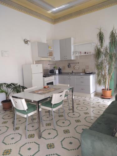 a kitchen with a table and chairs in a room at Maddalena House in Spello