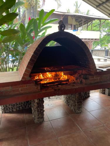 a stone pizza oven sitting on a patio at Perla Negra Beachfront in Puerto Viejo