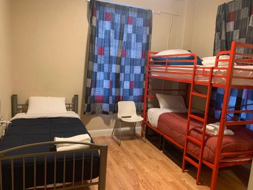 a room with two bunk beds and a chair at Orange Village Hostel in San Francisco