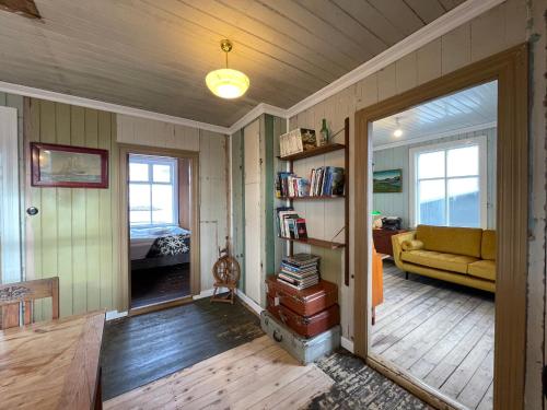 a living room with a couch and a table at The Old Bookstore in Flateyri