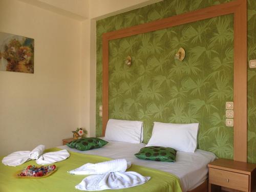 a bedroom with a bed with towels on it at Hotel Karagianni in Volos
