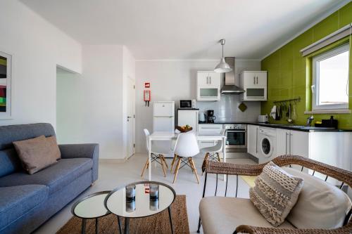 a living room with a couch and a table at Vivenda Brito in Carvoeiro