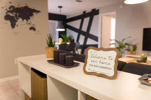 a counter with a welcome sign on it in a living room at Renovated 3 Br home near all main attractions in Kissimmee