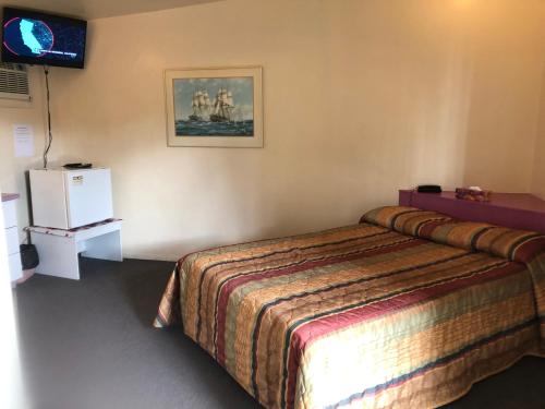 Un pat sau paturi într-o cameră la Motel Le Voyageur