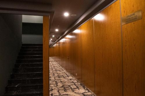 a hallway with wooden walls and stairs in a building at Grand Opera Hotel in Kutaisi