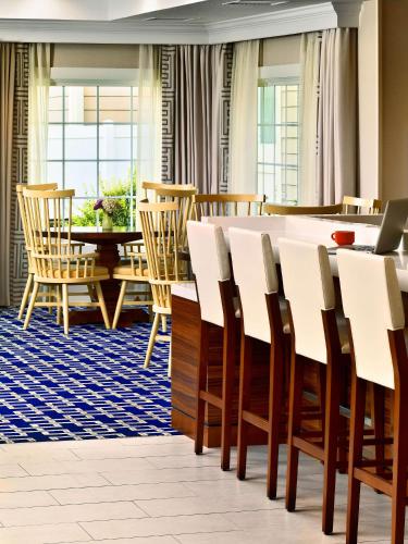 a dining room with a table and chairs at Sonesta ES Suites Somerset in Somerset