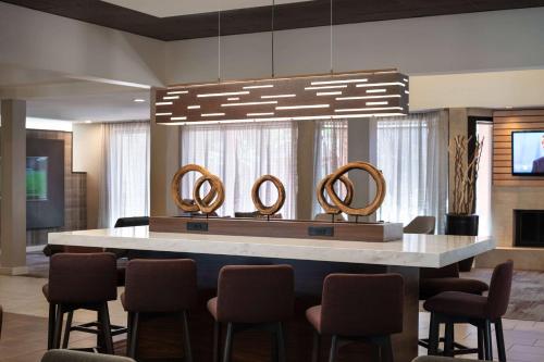 a lobby with a table with four mirrors on it at Sonesta Select Phoenix Camelback in Phoenix