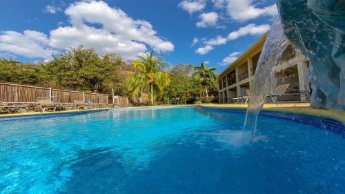 a large swimming pool with a water fountain at Hermosa Paradise in Playa Hermosa