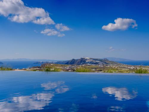 a view of a lake with a mountain in the background at Apikia Santorini in Pirgos