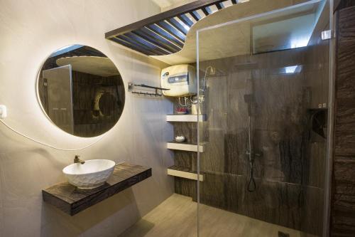 a bathroom with a sink and a mirror at Villa Alessa Puncak in Puncak