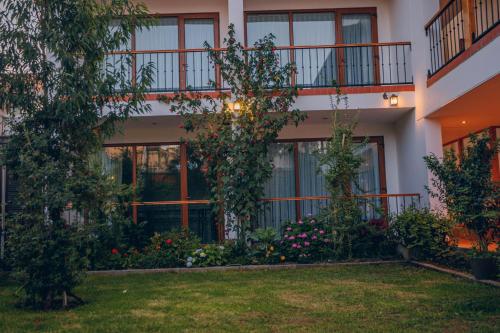 an apartment building with a garden in front of it at Saska Boutique Hotel in Cusco