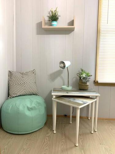 a desk with a lamp and a chair next to a table at Cute and cozy at Niagara Falls USA in Niagara Falls