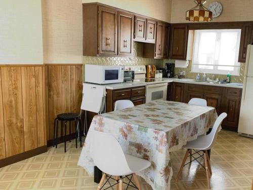 a kitchen with a table and chairs and a microwave at Cute and cozy at Niagara Falls USA in Niagara Falls