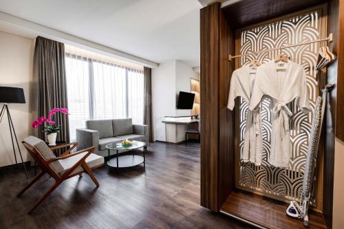 a living room with a door with a shirt hanging on it at Quest Prime Pemuda - Semarang in Semarang